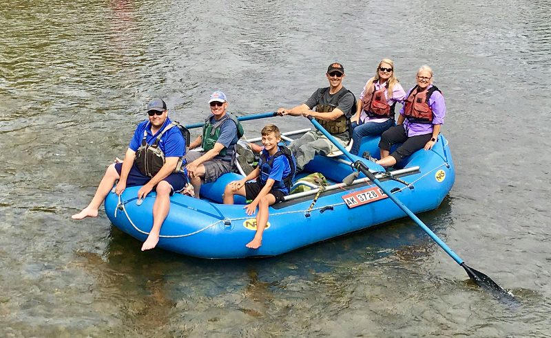 Guests are smiling on Willow Creek during a Guided Rafting Trip near Anchorage.